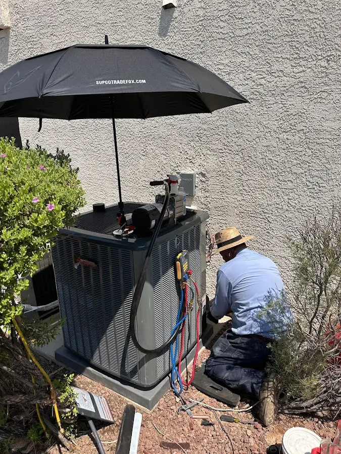 HVAC technician performing outdoor AC maintenance in Mount Airy